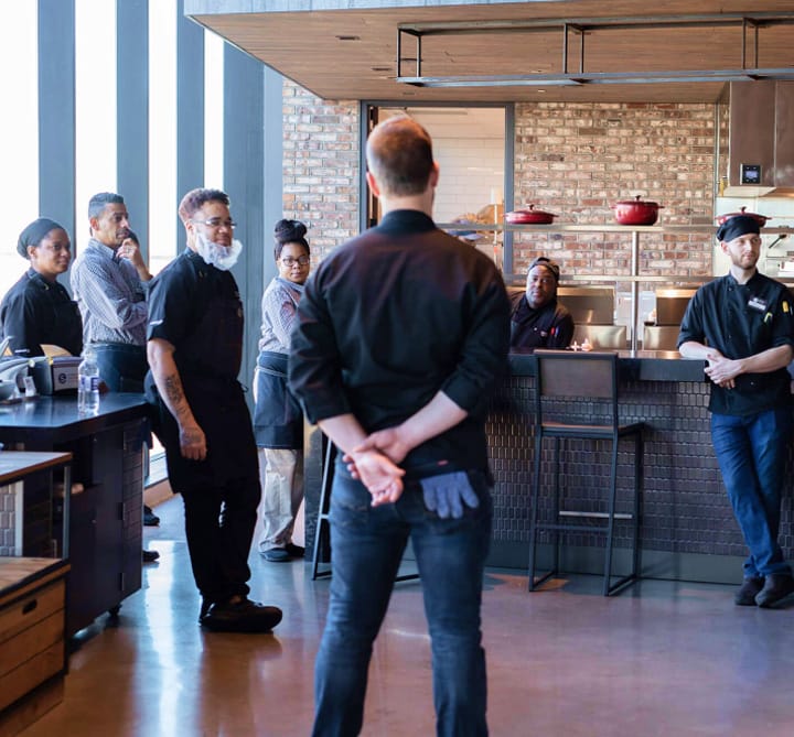 Man Speaking To Employees