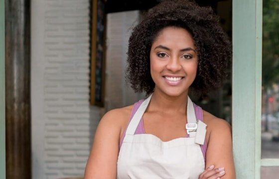 Smiling business owner wearing an apron.