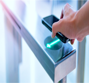 A person scanning their phone at an entry point.