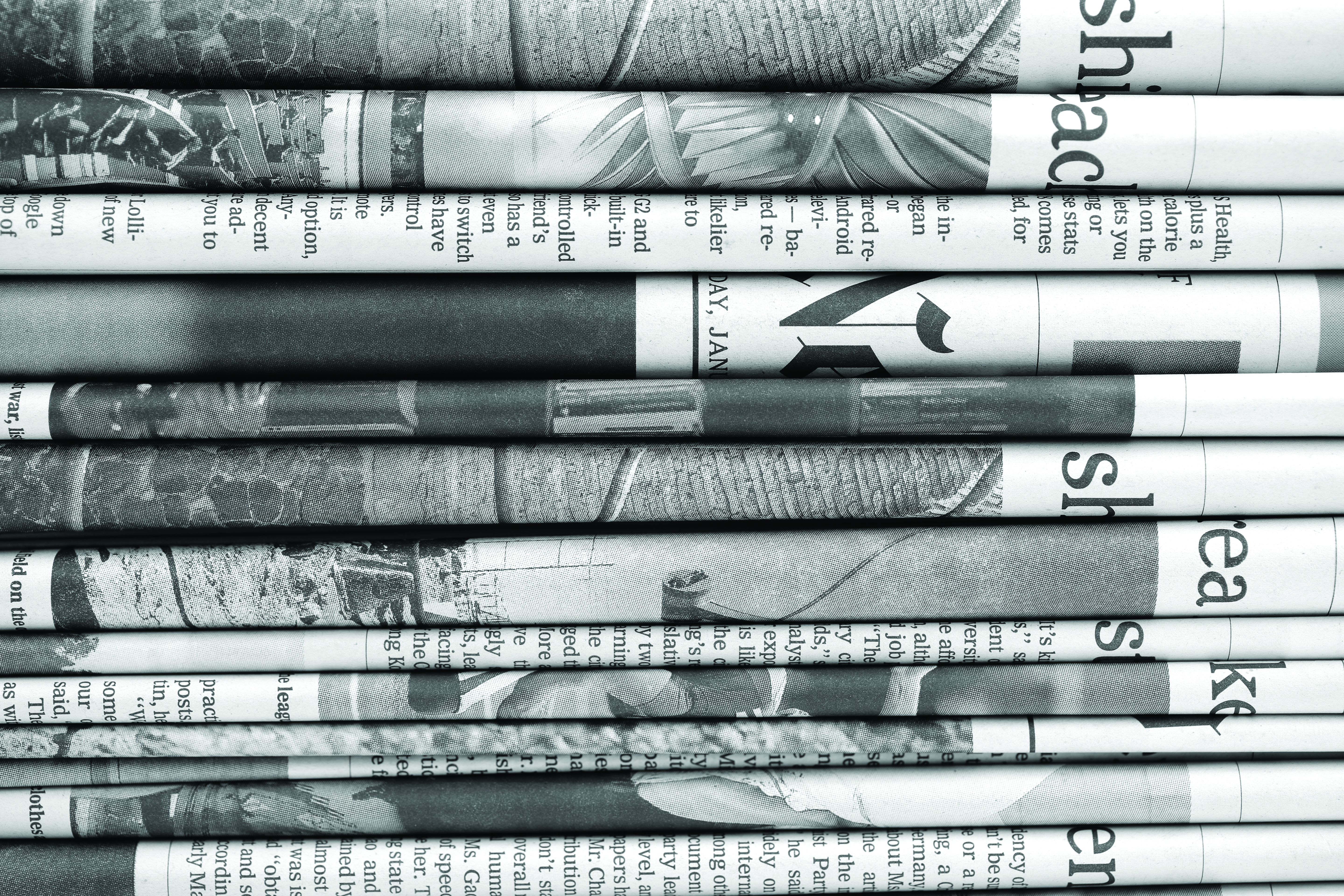 A stack of black and white newspapers.