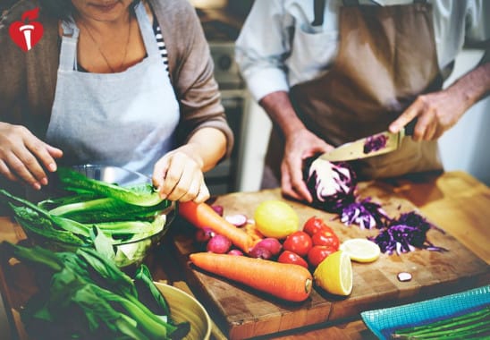 People preparing vegetables for a meal