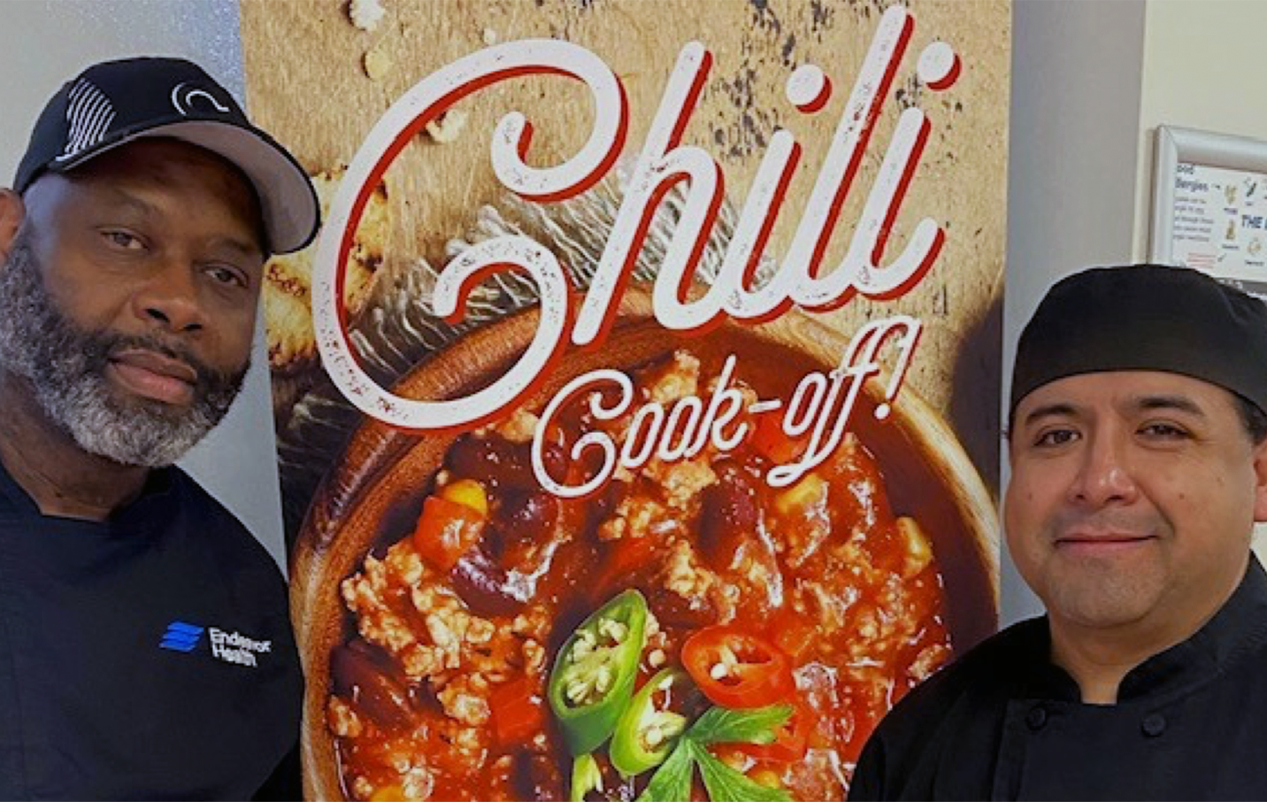 chefs pose with chili cook-off sign