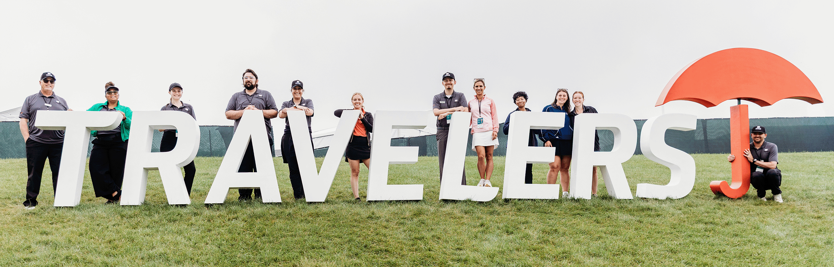 Aramark team posing with Travelers logo