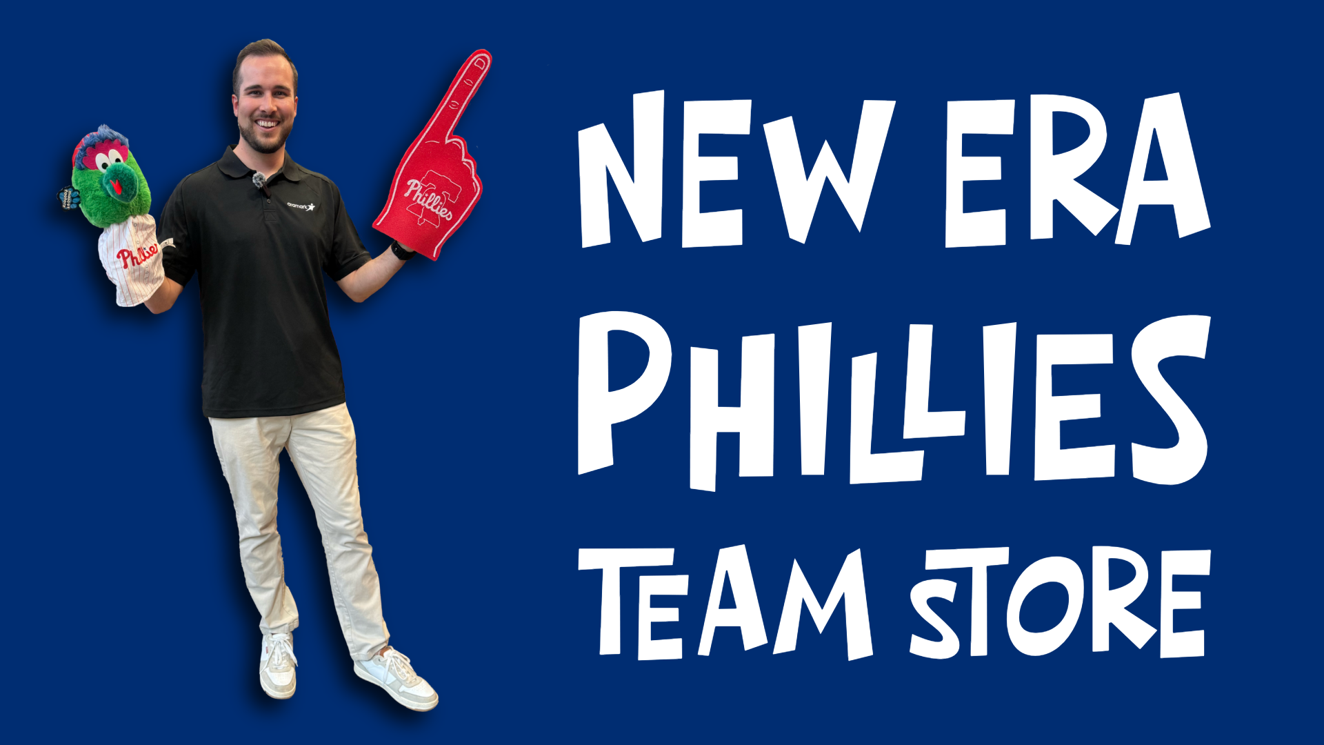 Conall holding up a foam finger and a Phillies Phanatic puppet