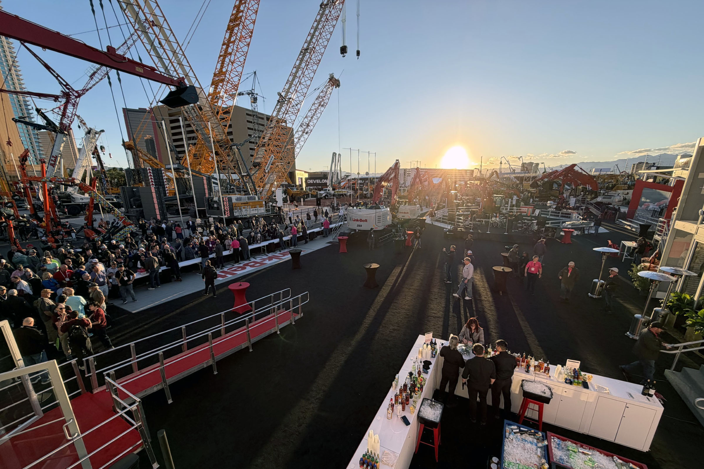 People standing in a community setting with industrial equiptment in the background.