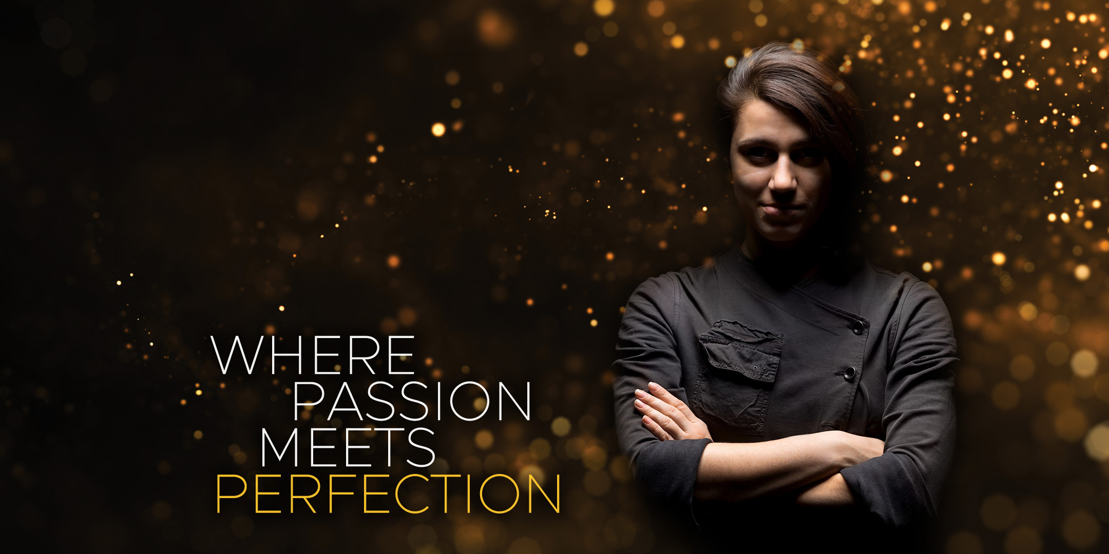 A chef in a black jacket standing with arms crossed, surrounded by gold specks of light and the words where passion meets perfection.
