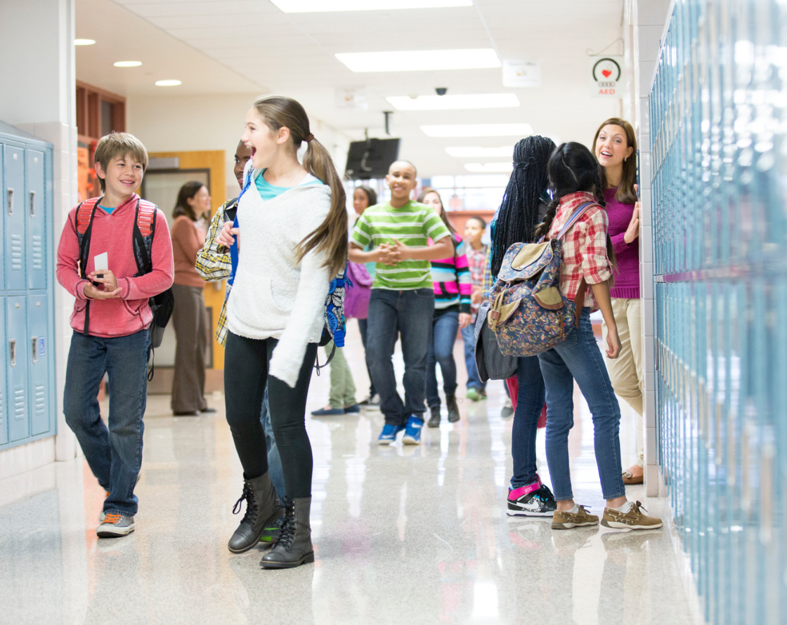 Kids walking through a hallway in school