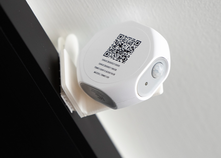 A wall-mounted camera with a QR code.