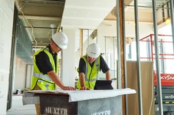 Aramark employees in white hard hats.