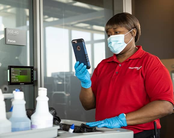Aramark employee with a cleaning cart