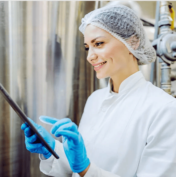 Female in hairnet looking at tablet