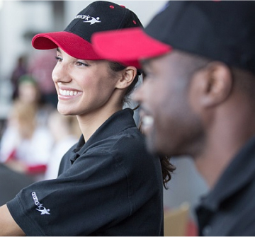 Smiling teammates in Aramark hats
