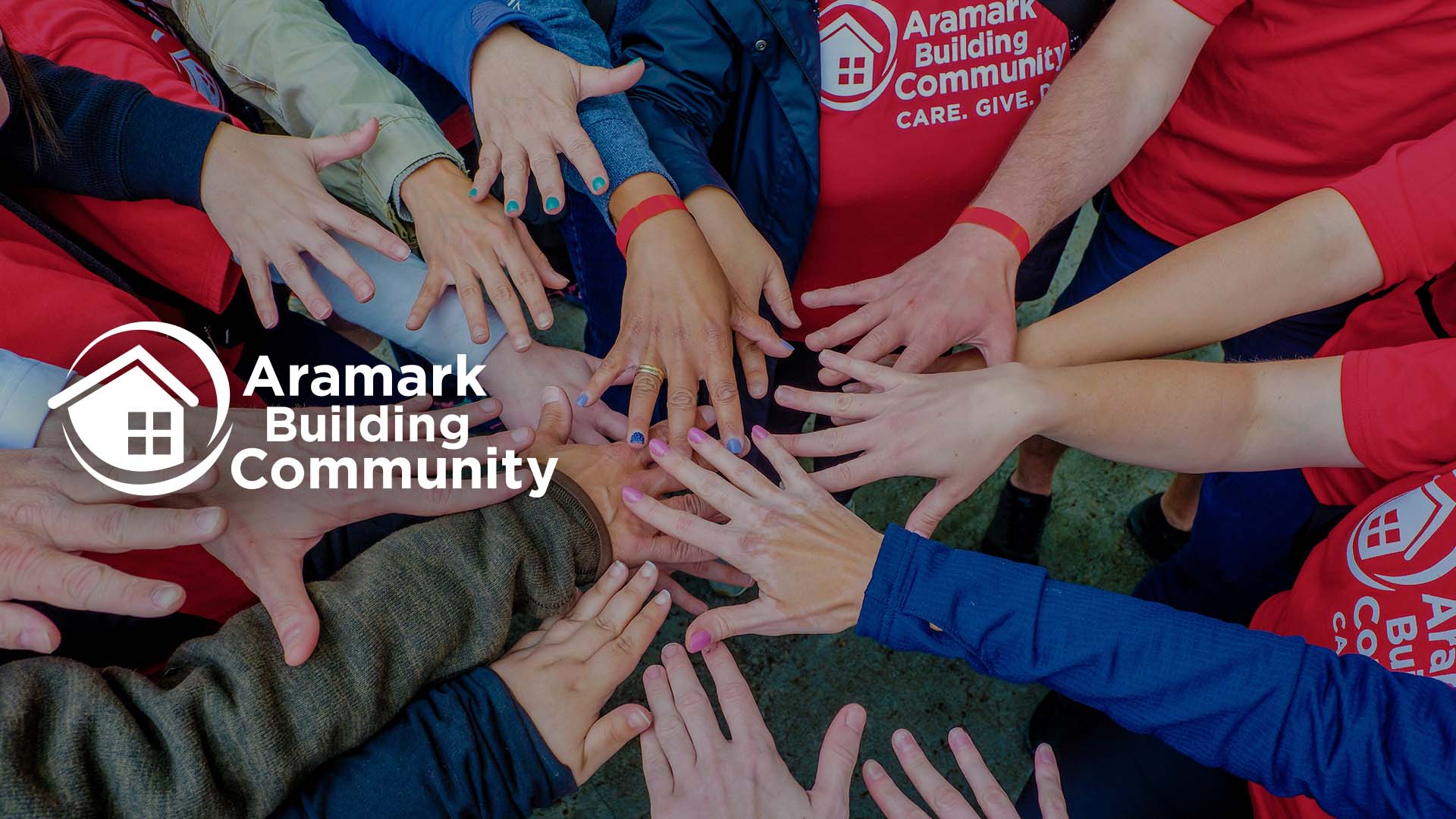 Volunteer hands in a circle together.