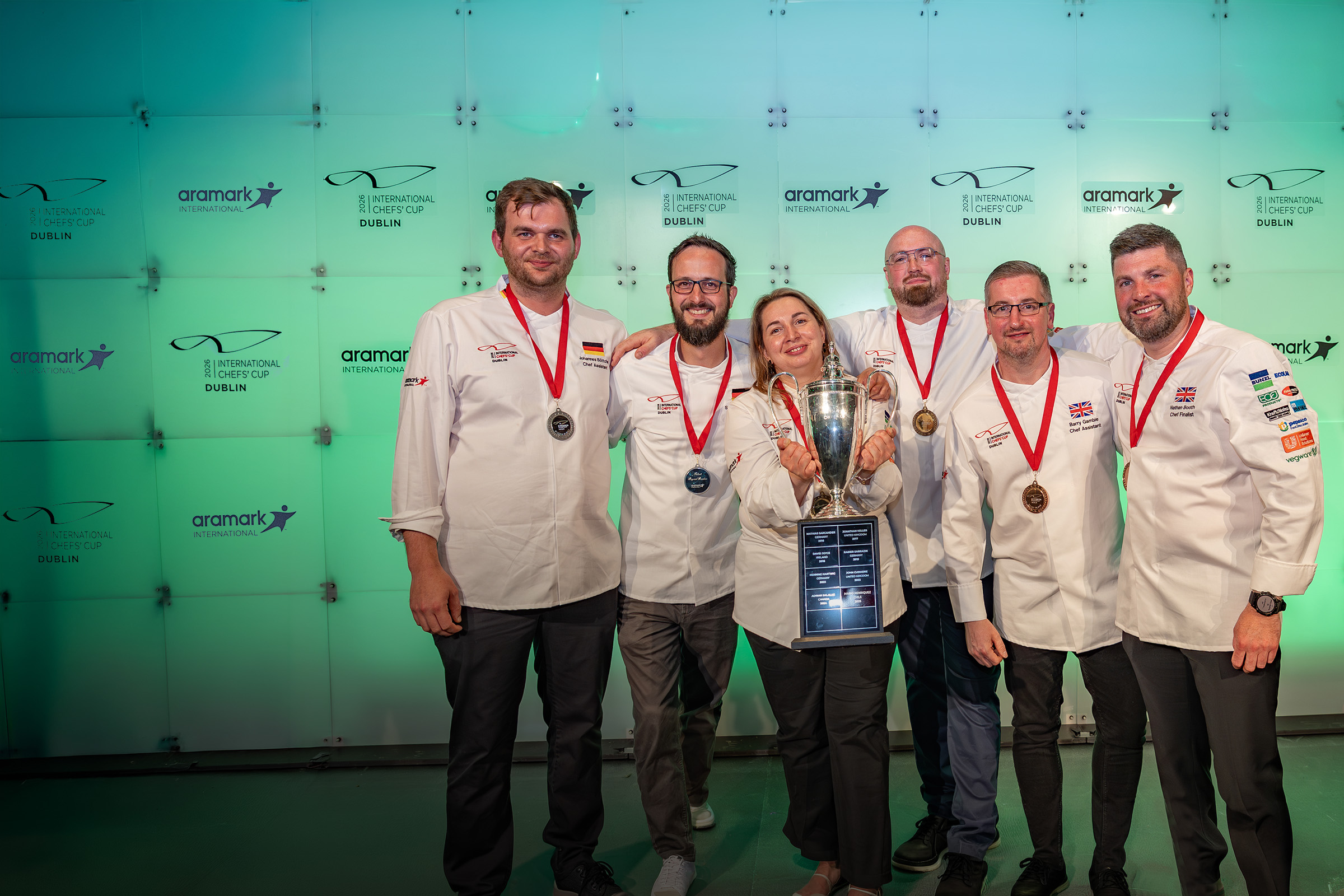 Smiling chefs holding up a trophy at the 2026 Aramark International Chefs’ Cup.
