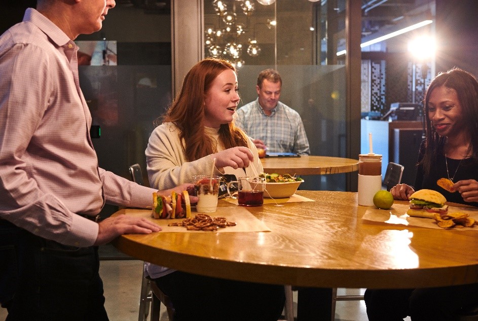 Woman smiling with food in front of her on a table