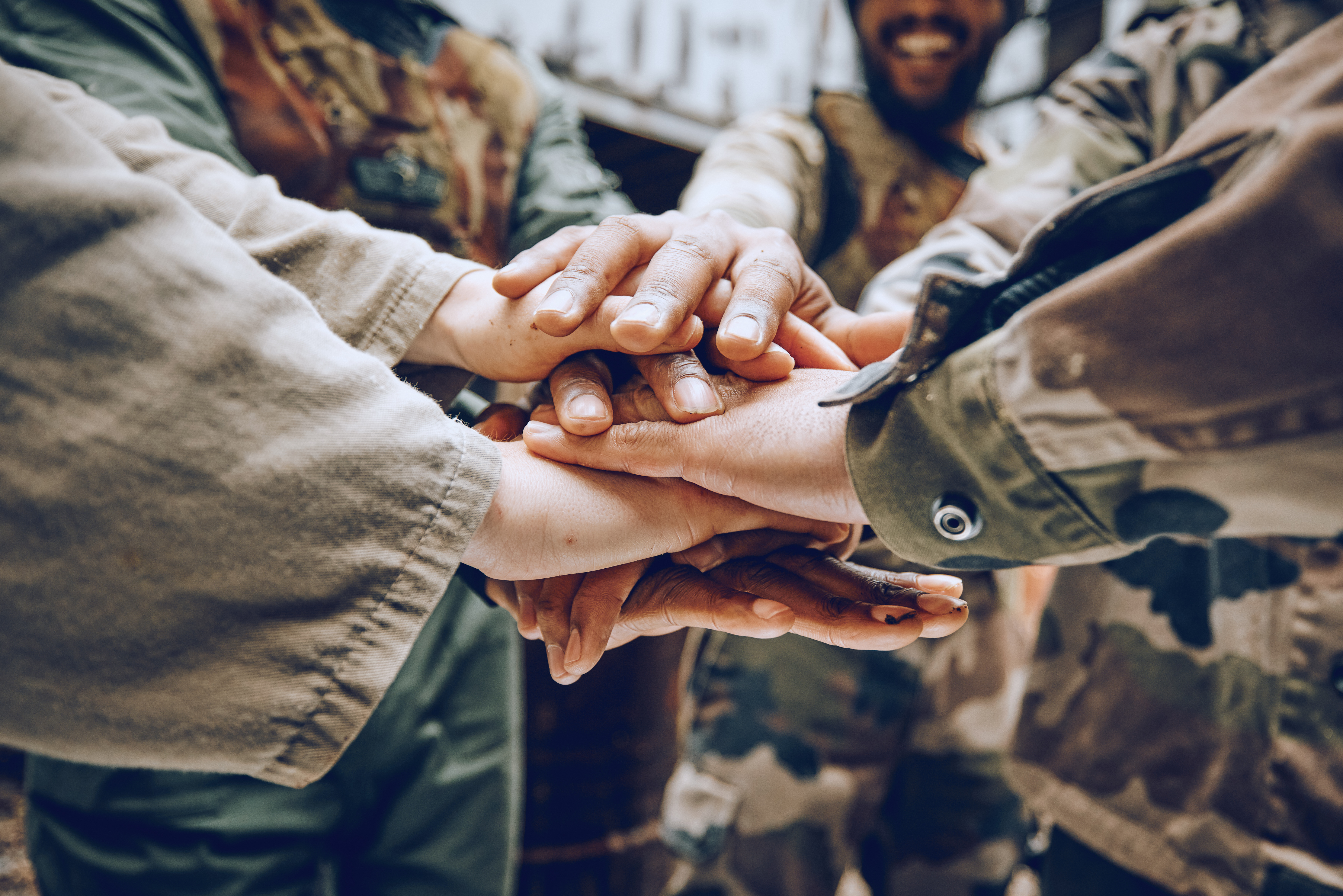 Military personnel with their hands in a circle.