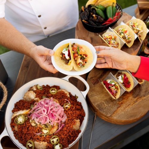 Tacos being handed to customer