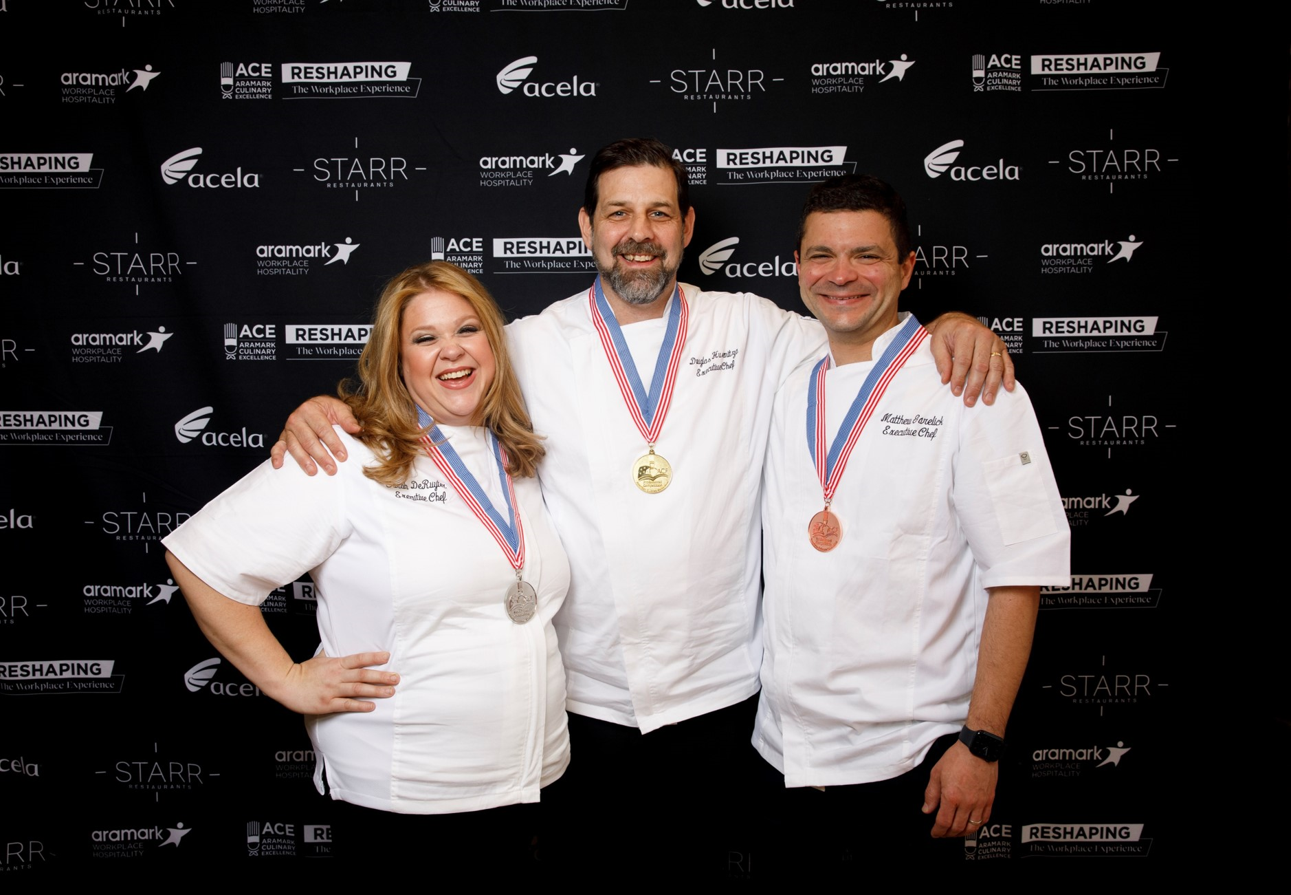 Three chef contestant winners smiling with medals