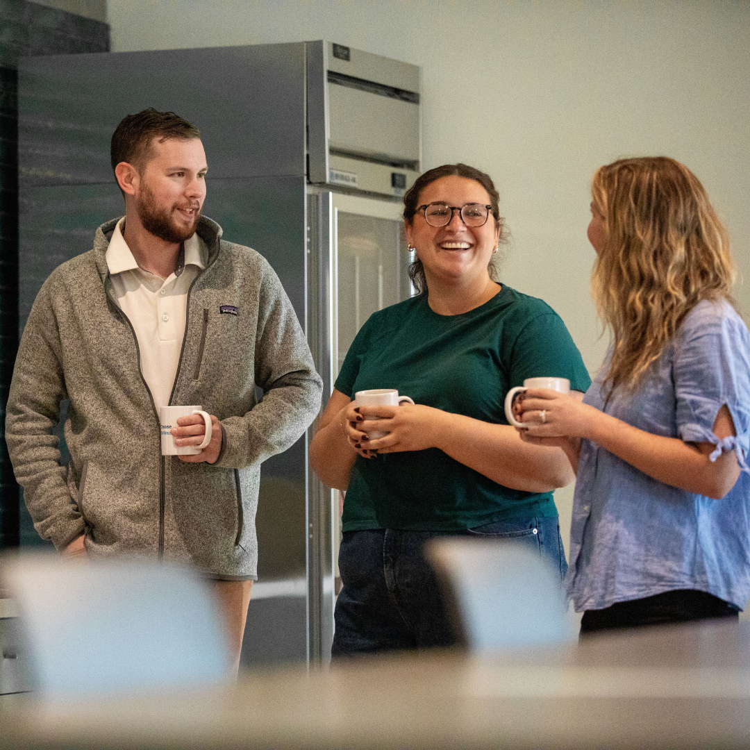 People standing around and drinking coffee.