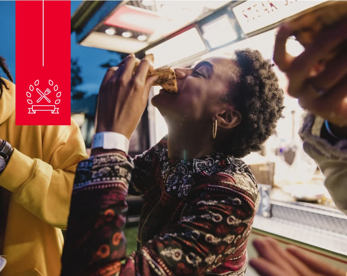 Woman enjoying pizza with friends.