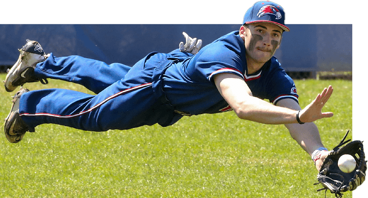 College athlete diving to catch a baseball with his mitt.