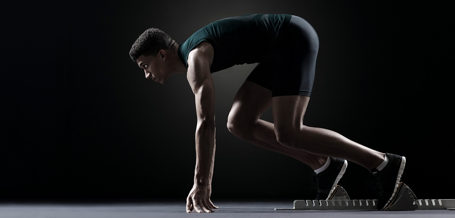 Student athlete positioned at track starting block.