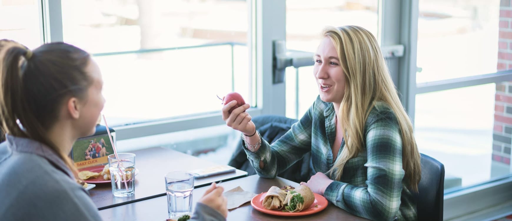 Girls having food and laughing.