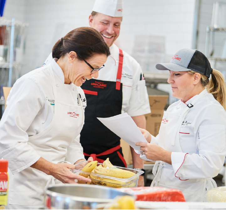 Aramark chefs laughing and preparing food.