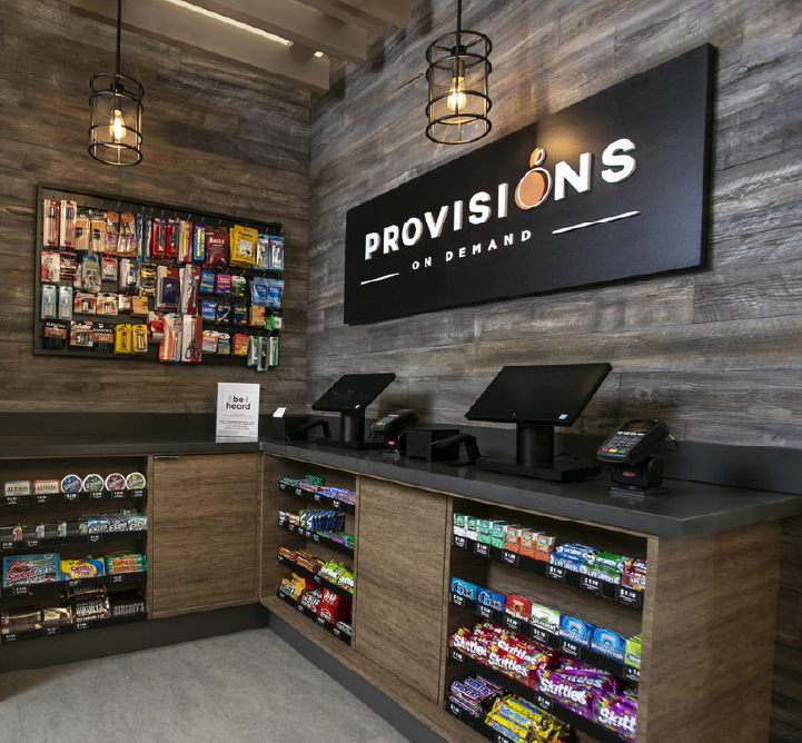A Provisions On Demand self-service vending stand stocked with snacks, candy, and other items.