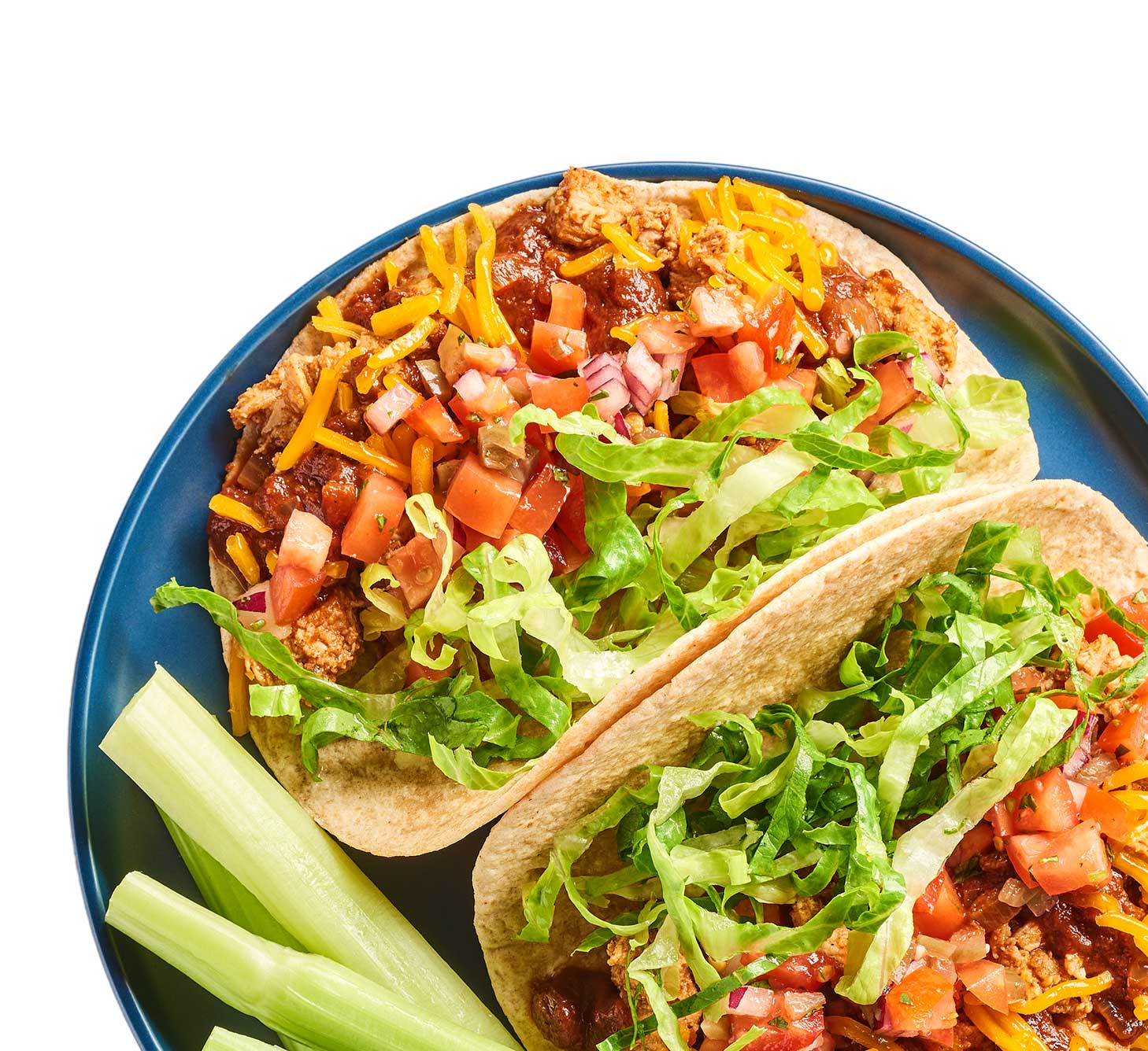 Tacos and a side of celery sticks on a plate.