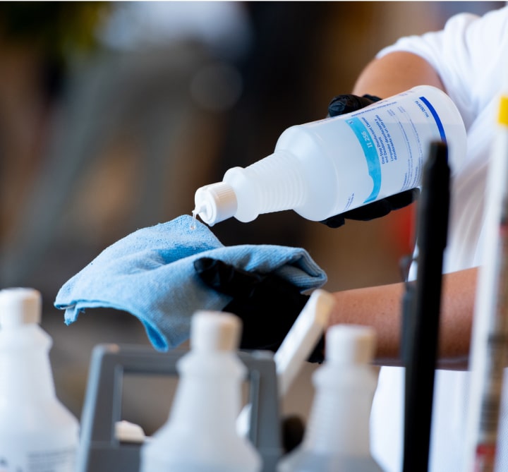 Pouring cleaning solution on cloth