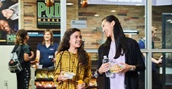Students buying items at a convenience market.