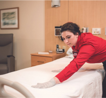 Service staff organizing hospital bed