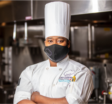 chef wearing a mask in kitchen
