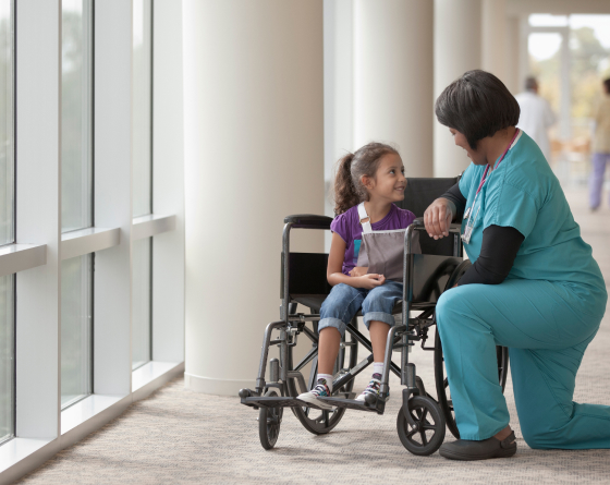 healthcare staff helping young patient