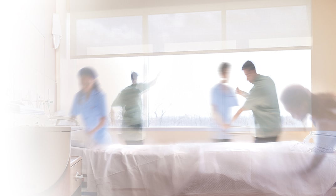 Workers cleaning a hospital room.