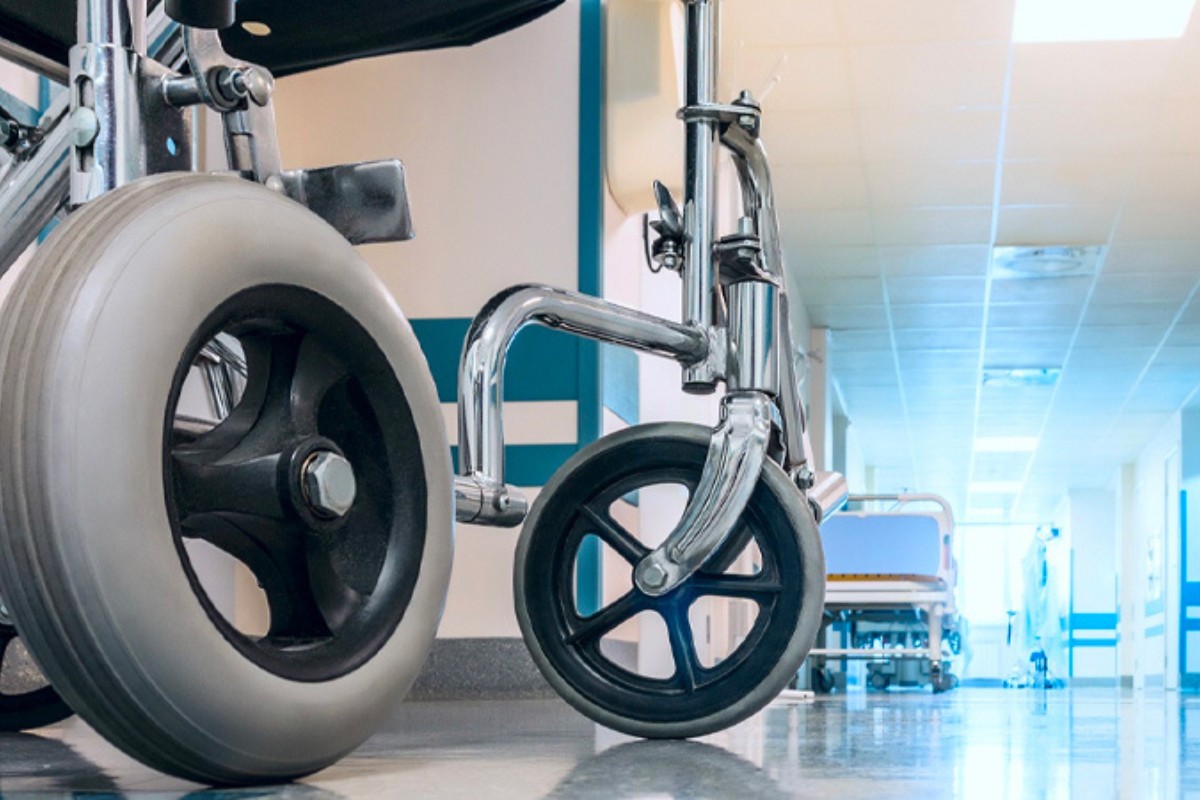 An empty wheelchair in a hospital hallway.