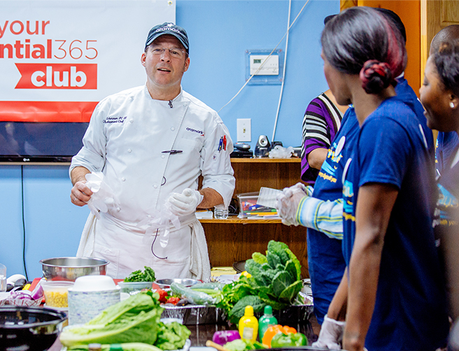 Aramark chef demonstrating the preparation of fresh vegetables.