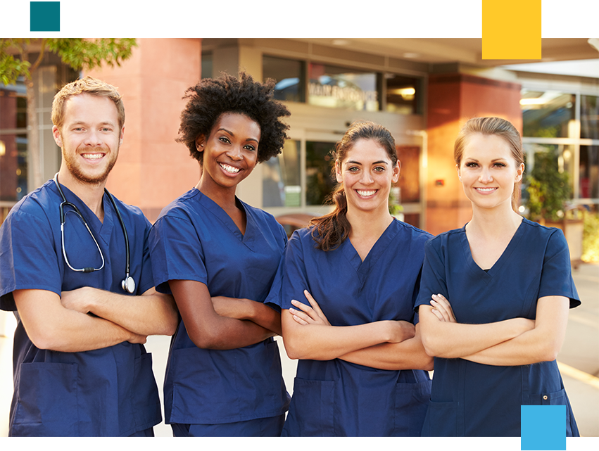 Male and female nurses smiling posed with crossed arms.