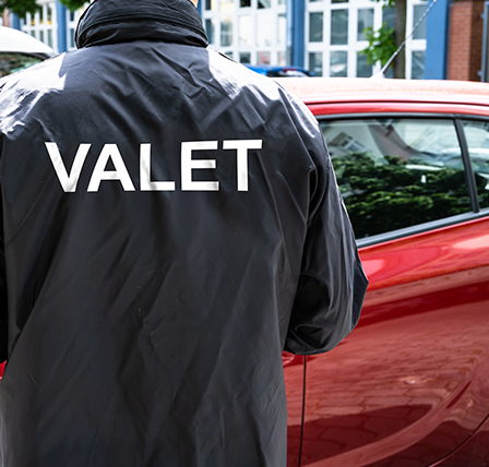 A worker in a valet jacket.