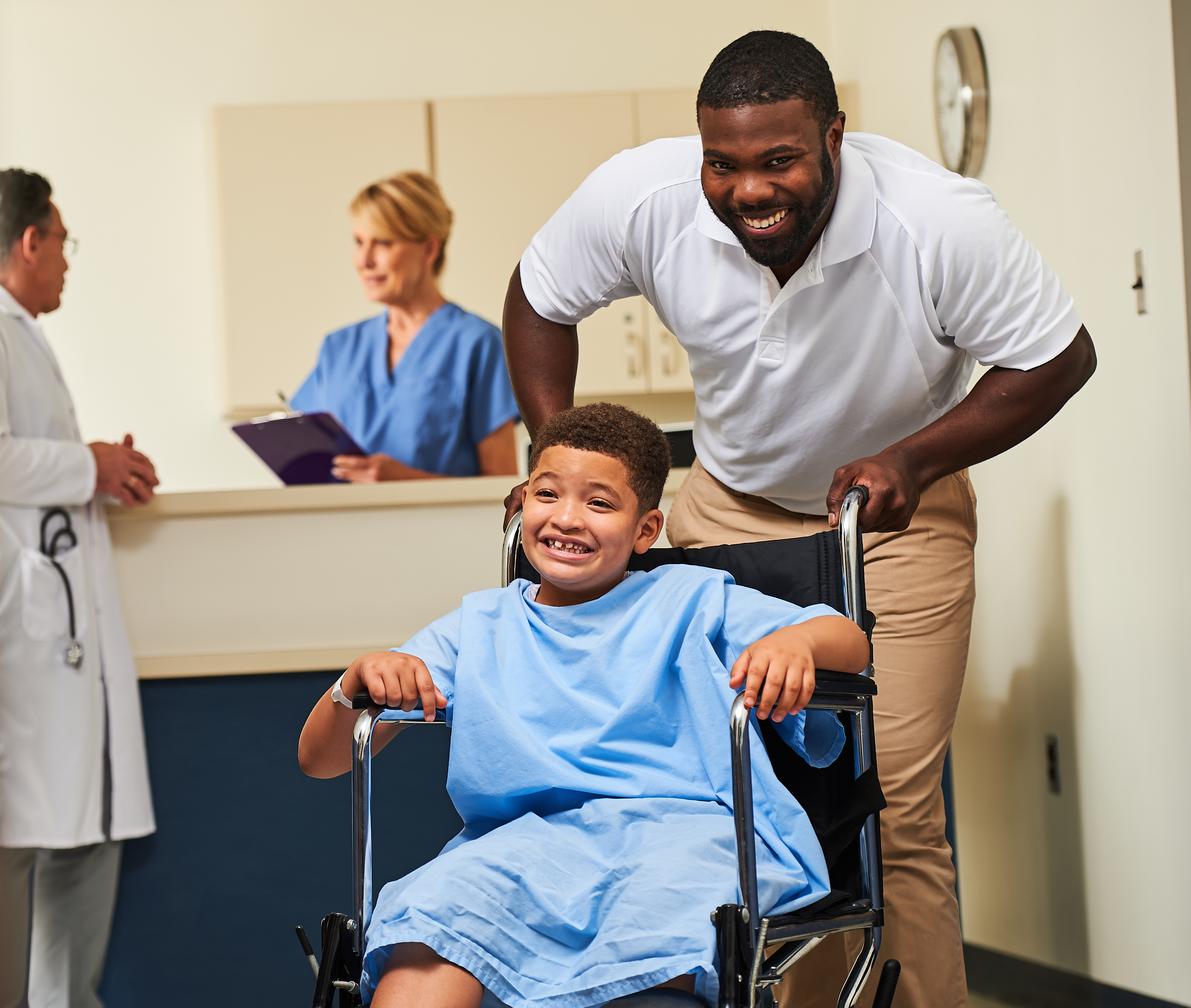 boy getting wheeled in wheel chair