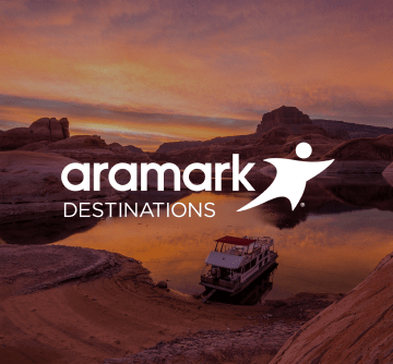The Aramark Destinations logo, and the lake and natural sandstone structures at Lake Powell, Arizona.