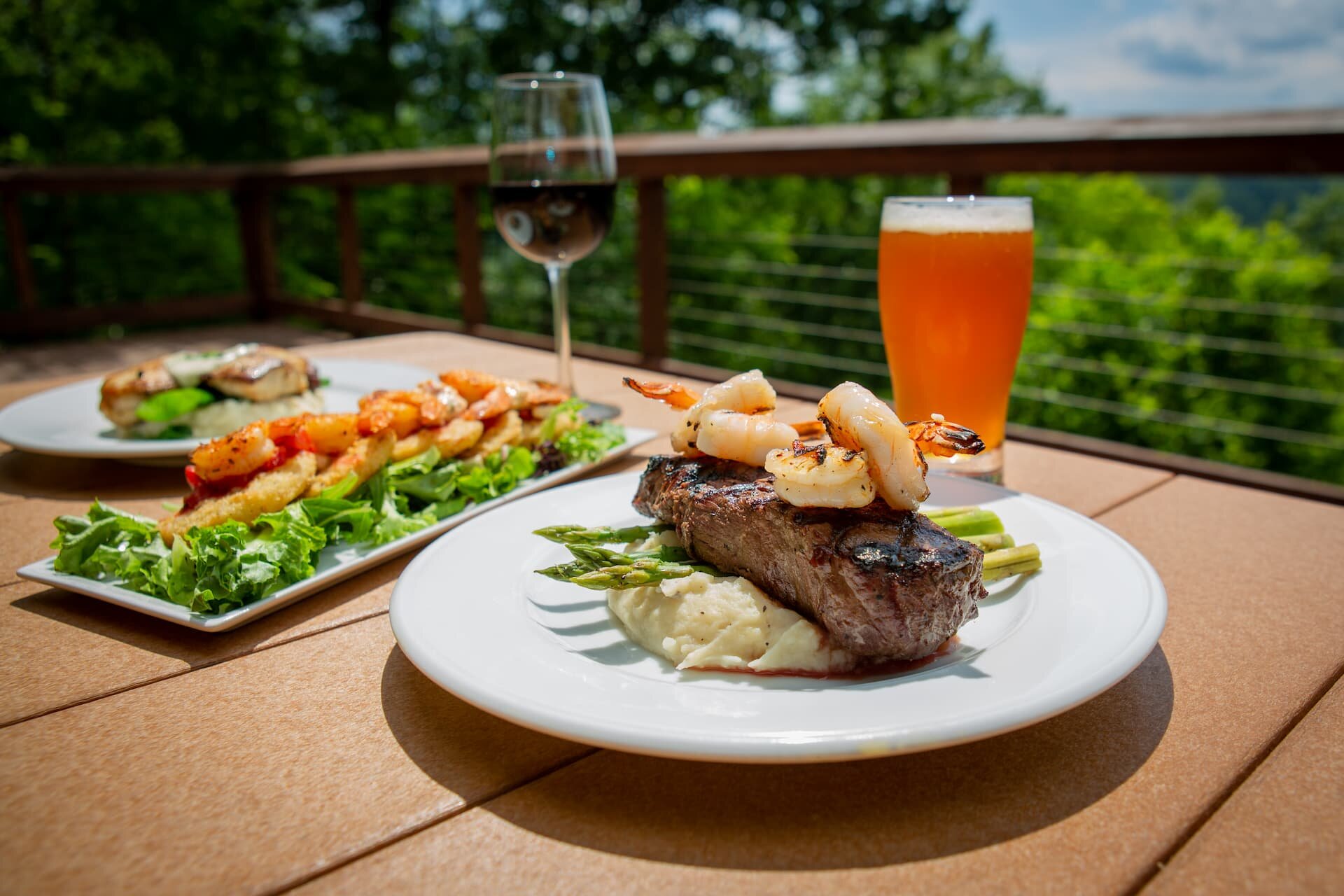 Plates of food and a glass of wine.