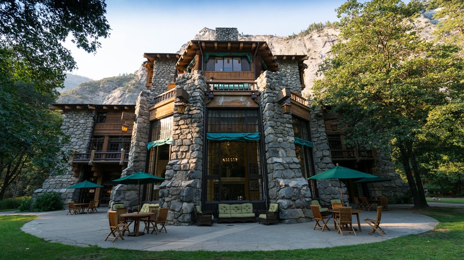 The patio of a historic stone building set up with outdoor seating.