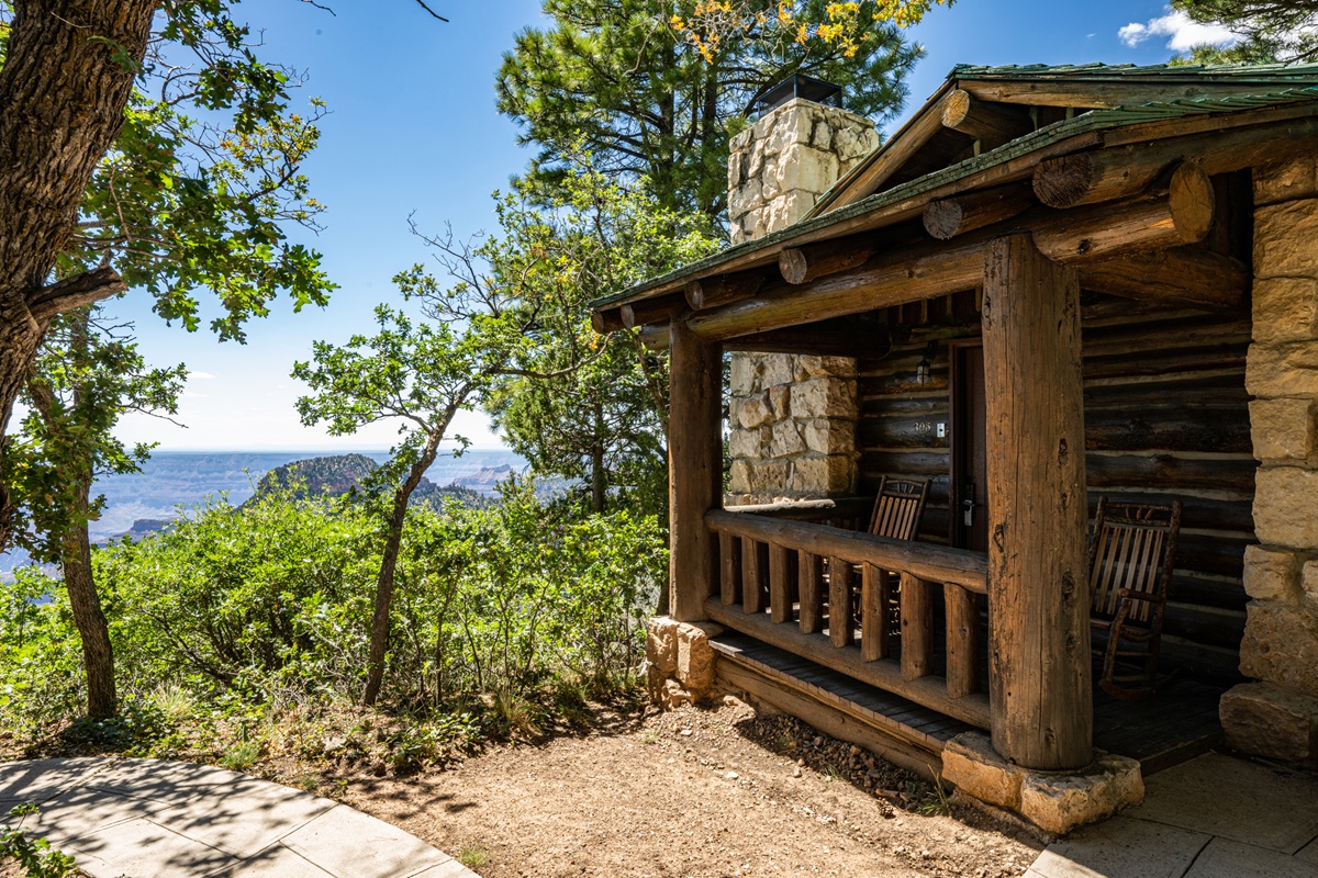 A log cabin surrounded by trees.