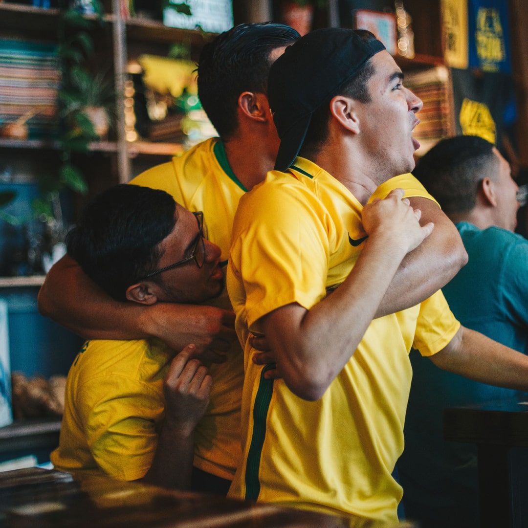 Sports fans huddling in excitement